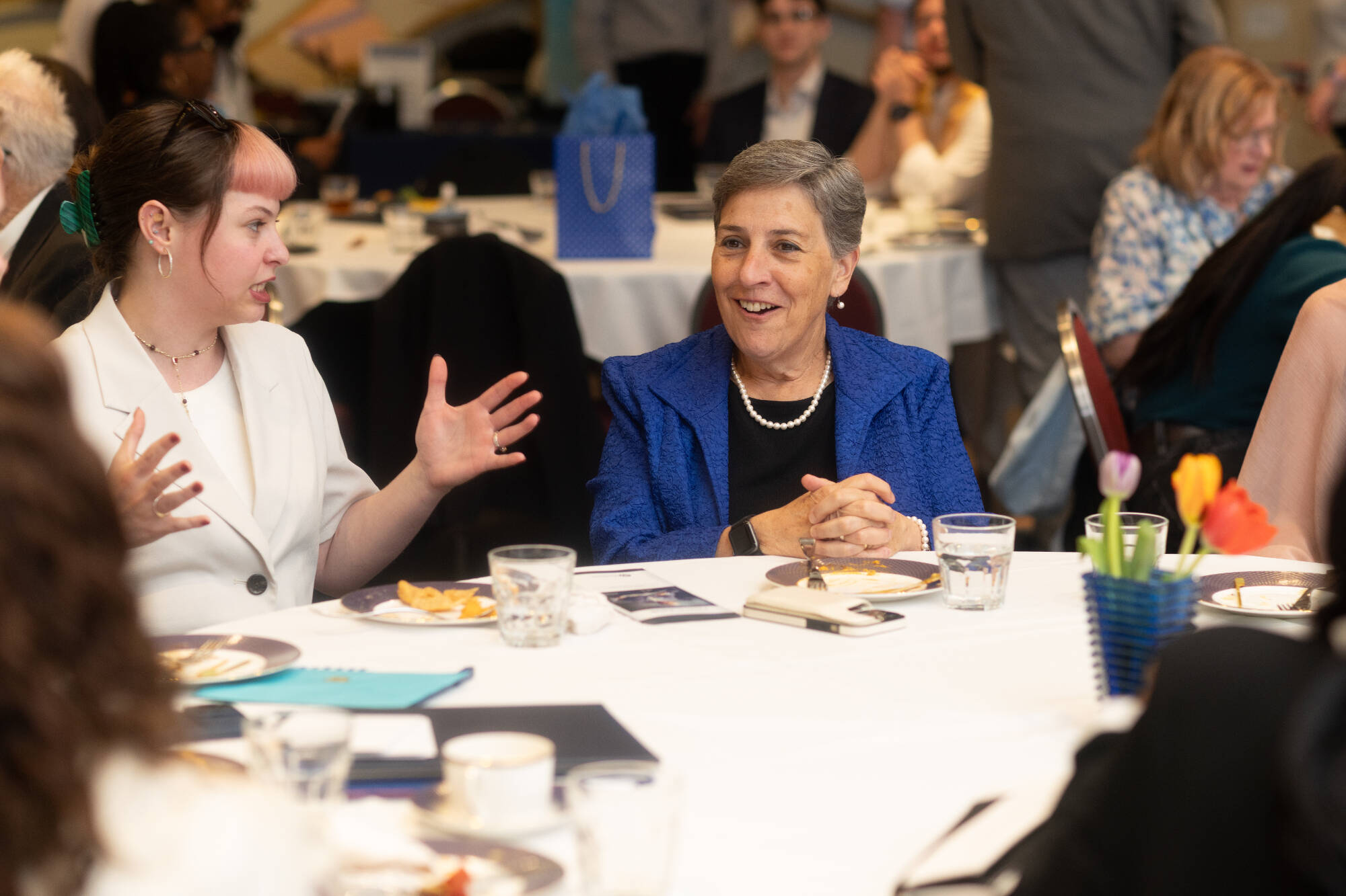 Cook Leadership Academy fellows speak with the keynote speaker at the annual Celebration of Graduates.